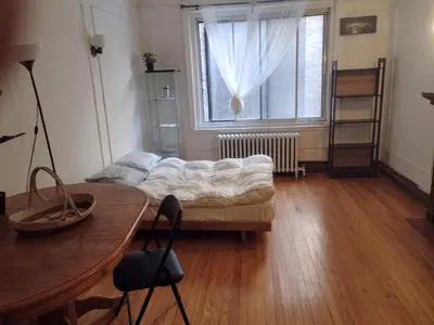a living room with a couch in front of a window at Antic Style with high ceiling in Montréal