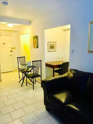 a living room with a couch and chairs and a table at Stylish Montreal Apartment Comfortable Stay in the Golden Square Mile in Montréal