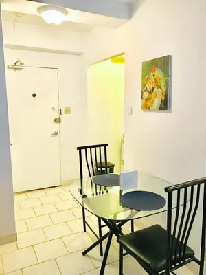 a dining room with a glass table and chairs at Stylish Montreal Apartment Comfortable Stay in the Golden Square Mile in Montréal
