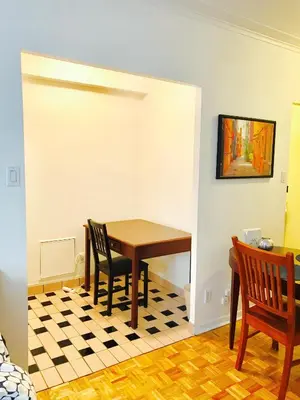a dining room with a table and chairs at Stylish Montreal Apartment Comfortable Stay in the Golden Square Mile in Montréal