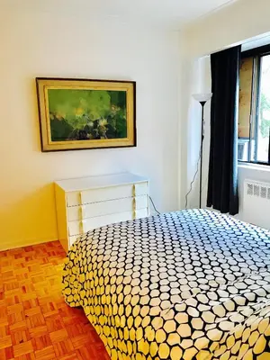 a bedroom with a bed and a painting on the wall at Stylish Montreal Apartment Comfortable Stay in the Golden Square Mile in Montréal