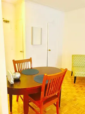 a dining room table with two chairs and a table at Stylish Montreal Apartment Comfortable Stay in the Golden Square Mile in Montréal