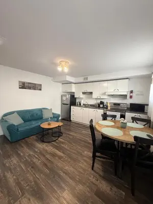 a living room with a couch and a table at Charmant appartement au sous-sol in Longueuil