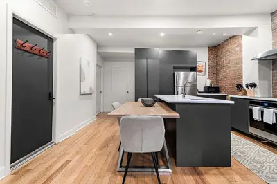 a kitchen with a table and a chair in it at The Ontario Loft Suites in Montréal