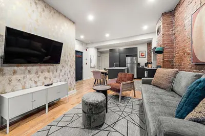 a living room with a couch and a flat screen tv at The Ontario Loft Suites in Montréal