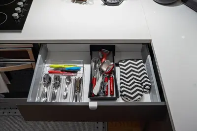 a drawer filled with utensils in a cabinet at The Ontario Loft Suites in Montréal