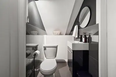 a bathroom with a toilet and a sink and a mirror at The Ontario Loft Suites in Montréal