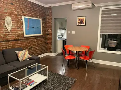 a living room with a couch and a table at cozy apartment in the heart of downtown Montreal in Montréal