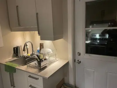 a kitchen with a sink and a counter with a sink at cozy apartment in the heart of downtown Montreal in Montréal