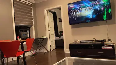 a living room with a flat screen tv on the wall at cozy apartment in the heart of downtown Montreal in Montréal