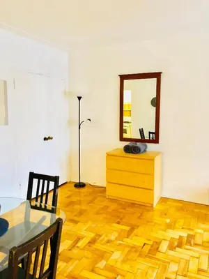 a dining room with a table and a mirror at Stylish Montreal Apartment Comfortable Stay in the Golden Square Mile in Montréal