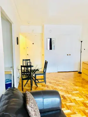 a living room with a couch and a table at Stylish Montreal Apartment Comfortable Stay in the Golden Square Mile in Montréal