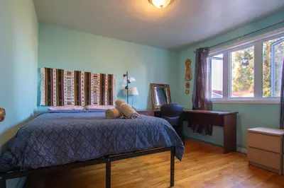 a bedroom with a bed with a teddy bear on it at Maison cosy - 6p - Proche de Centropolis & Carrefour Laval in Laval