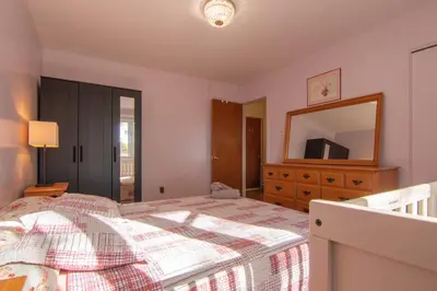 a bedroom with a bed and a dresser and a mirror at Maison cosy - 6p - Proche de Centropolis & Carrefour Laval in Laval