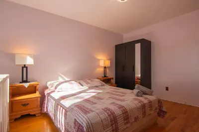 a bedroom with a bed and a dresser and a mirror at Maison cosy - 6p - Proche de Centropolis & Carrefour Laval in Laval