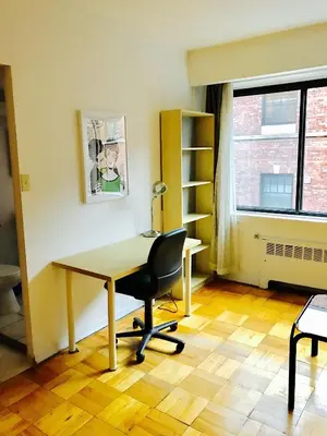 an office with a desk and a chair and a window at Stylish Montreal Apartment Comfortable Stay in the Golden Square Mile in Montréal