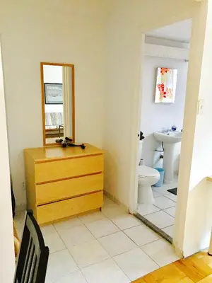 a bathroom with a wooden dresser and a mirror at Stylish Montreal Apartment Comfortable Stay in the Golden Square Mile in Montréal