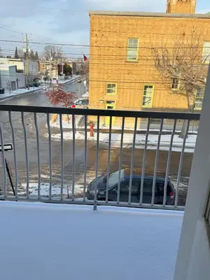 a balcony with a car parked on a street at Cozy & spacious 3 BDR condo in Montréal