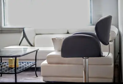 a living room with a couch and a chair and a table at Appartement chic in Montréal