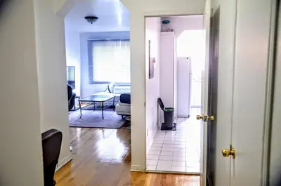 an open door to a living room with a table at Appartement chic in Montréal