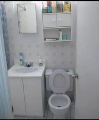 a small bathroom with a toilet and a sink at Appartement chic in Montréal
