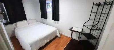 a bedroom with a white bed and a window at Cute 2 BDR condo in Montréal