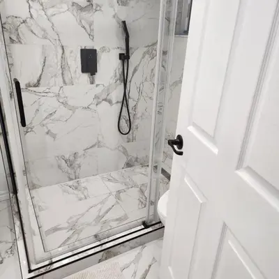 a bathroom with a shower with white marble at Cute 2 BDR condo in Montréal