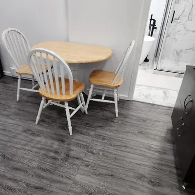 a dining room table with two chairs and a table at Cute 2 BDR condo in Montréal