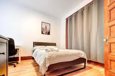 a bedroom with a bed and a tv and a window at Great 3B unit on Saint-Urbain in Montréal