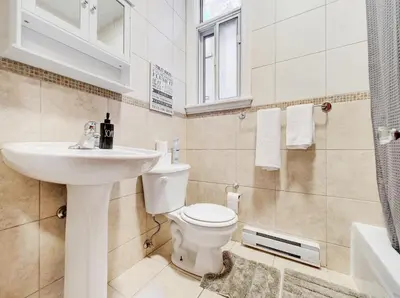 a bathroom with a toilet and a sink at Great 3B unit on Saint-Urbain in Montréal