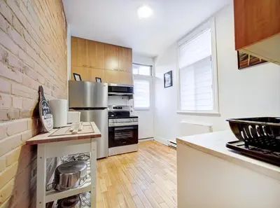 a kitchen with a stainless steel stove top oven at Great 3B unit on Saint-Urbain in Montréal