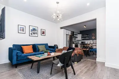 a living room with a blue couch and a table at Hochelaga 1 in Montréal