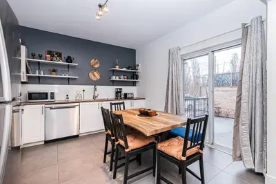 a kitchen with a wooden table and chairs in a kitchen at Hochelaga 1 in Montréal