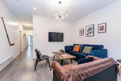 a living room with a blue couch and a table at Hochelaga 1 in Montréal