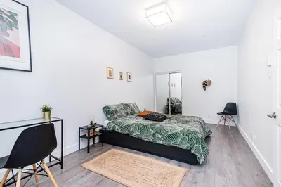 a bedroom with a bed and a desk and a chair at Hochelaga 1 in Montréal