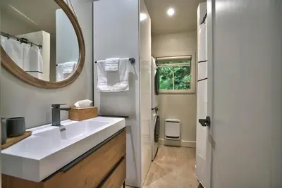a bathroom with a white sink and a mirror at Le Southière, minimum 30 nuits in Magog-Orford
