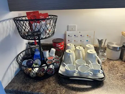 a counter with cups and containers on a shelf at Pointe Calumet, 30 minutes de Montréal max 8 pers in Pointe-Calumet
