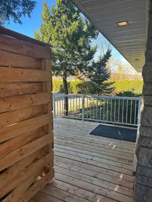 a wooden fence on a deck with a gate at Pointe Calumet, 30 minutes de Montréal max 8 pers in Pointe-Calumet