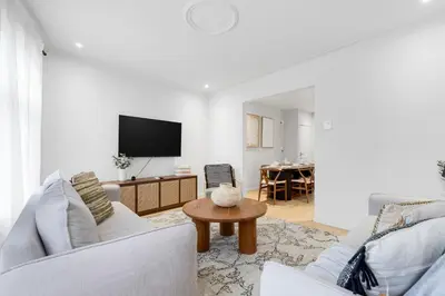 a living room with two white couches and a table at Boho Luxe 2-Floor Retreat Sleeps 6 Private Patio in Montréal