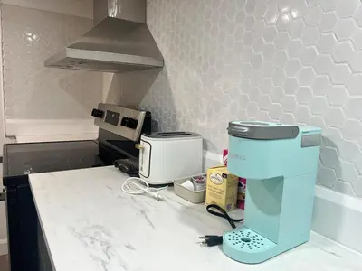 a kitchen with a counter with a coffee maker on it at 10 minutes to Montreal entire place 2 bedrooms private entrance in Laprairie