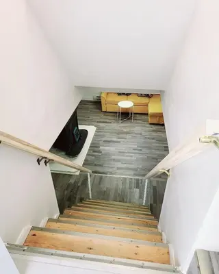 a staircase leading up to a room in a house at 10 minutes to Montreal entire place 2 bedrooms private entrance in Laprairie