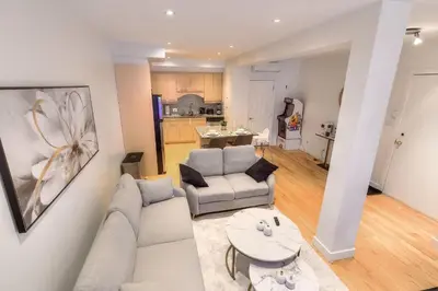 a living room with a couch and a table at Take a break in a modern loft on the plateau Walk score 99 in Montréal
