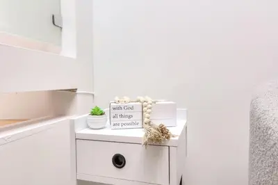 a white cabinet with a sign on it in a bedroom at Take a break in a modern loft on the plateau Walk score 99 in Montréal