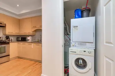 a kitchen with a washer and dryer in a room at Take a break in a modern loft on the plateau Walk score 99 in Montréal