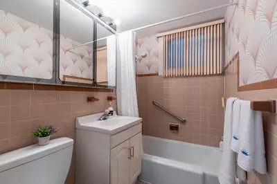 a bathroom with a sink and a toilet and a tub at Cozy Montreal Entire Apartment-3min walk to Metro-free parking-Botanical garden-biodome in Montréal