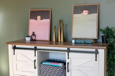 a console table with two pictures on top of it at Cozy Montreal Entire Apartment-3min walk to Metro-free parking-Botanical garden-biodome in Montréal