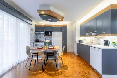 a kitchen with a table and chairs in a room at Cozy Montreal Entire Apartment-3min walk to Metro-free parking-Botanical garden-biodome in Montréal