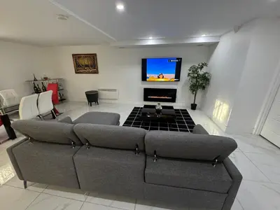 a living room with a couch and a flat screen tv at Rima in Montréal