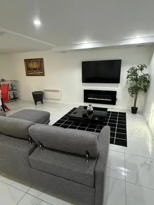 a living room with two couches and a flat screen tv at Rima in Montréal