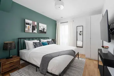 a bedroom with a large bed with blue walls at Mont Royal Prime Residence in Montréal